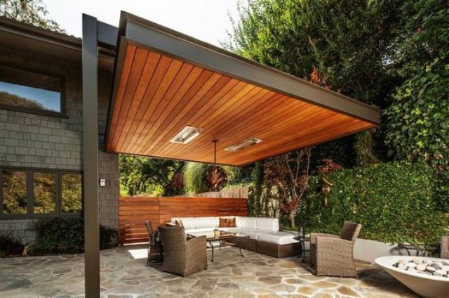 03 modern pergola built to one of the houses walls with a living room.jpg
